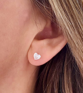 sterling silver sparkly heart studs on model's ear