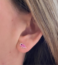 Load image into Gallery viewer, model wearing sterling silver pink triceratops dinosaur studs