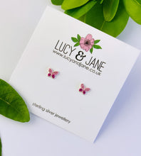 Load image into Gallery viewer, small pink sterling silver butterfly studs on a branded Lucy and Jane card