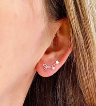 Load image into Gallery viewer, sterling silver bow and star earrings on model