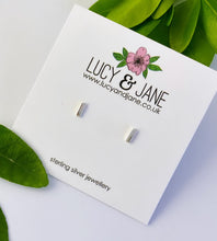 Load image into Gallery viewer, sterling silver dash stud earrings on a white backing card