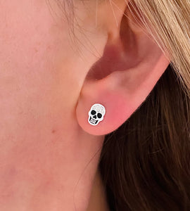 sterling silver skull studs on model's ear