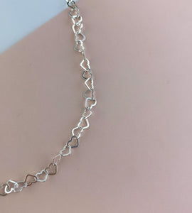 detail of the linked hearts anklet in sterling sivler