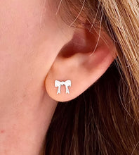 Load image into Gallery viewer, sterling silver flat bow studs on model&#39;s ear