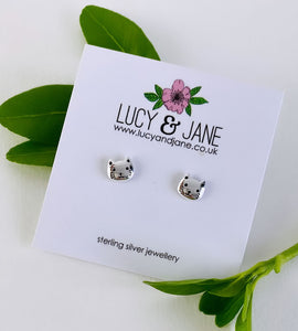 sterling silver cat head studs on a white backing card