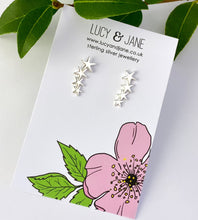 Load image into Gallery viewer, sterling silver star climber earrings on a backing card